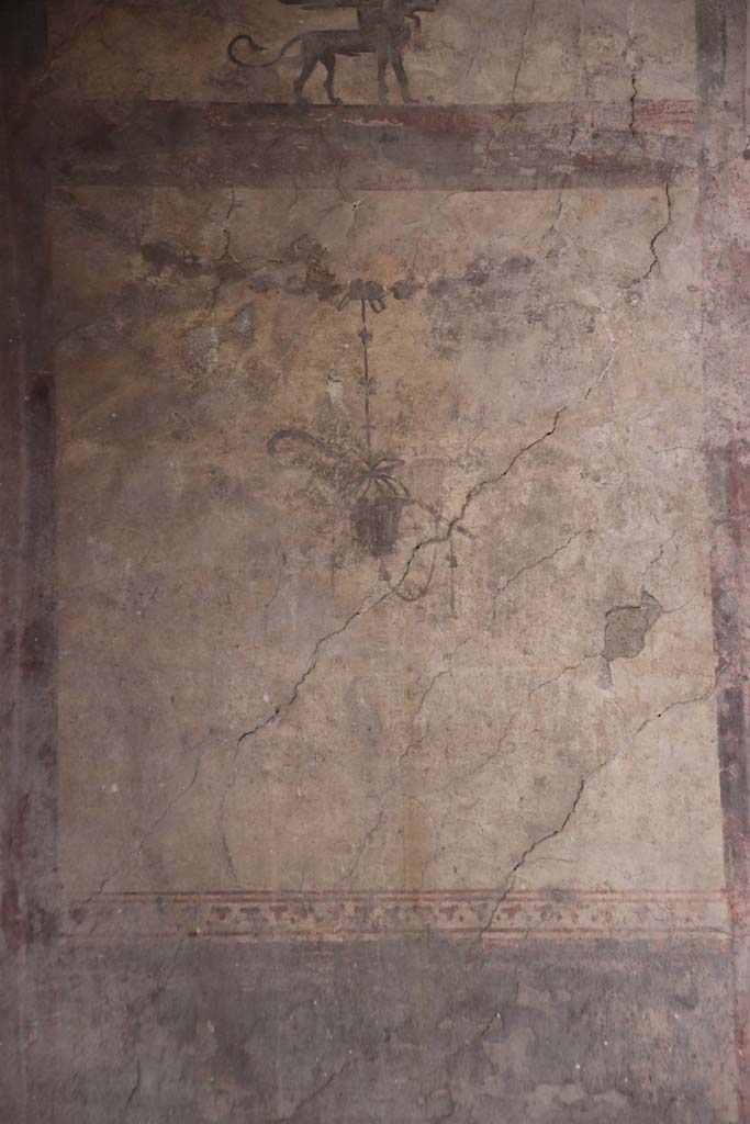 IV.21, Herculaneum. October 2020.  
Room 24, detail of painted decorations, below Sphynx, from south end of upper west wall of atrium.
Photo courtesy of Klaus Heese. 
