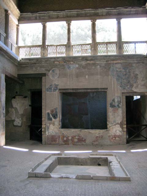 V.1 Herculaneum. May 2010. North wall of atrium, remains of painted decoration on west side of doorway to room 9. 