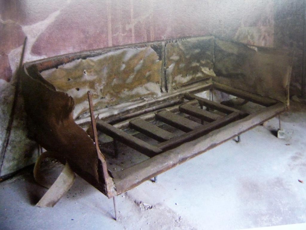 V.5, Herculaneum. Carbonised wooden bed in situ in room with three windows.
Photo with kind permission of Prof. Andrew Wallace-Hadrill.
See Wallace-Hadrill, A. (2011). Herculaneum, Past and Future. London, Frances Lincoln Ltd., (p.216/217)
