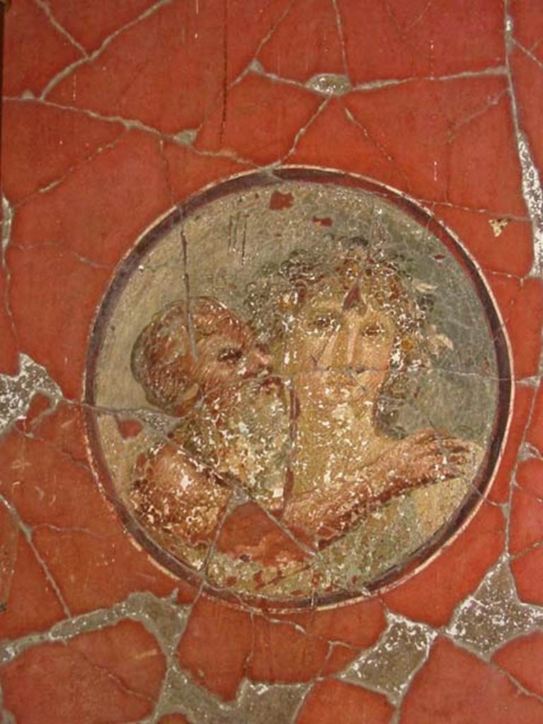 V.15 Herculaneum, May 2003. 
Tablinum, medallion showing an old Silenus and Maenad, from north end of east wall.
Photo courtesy of Nicolas Monteix.

