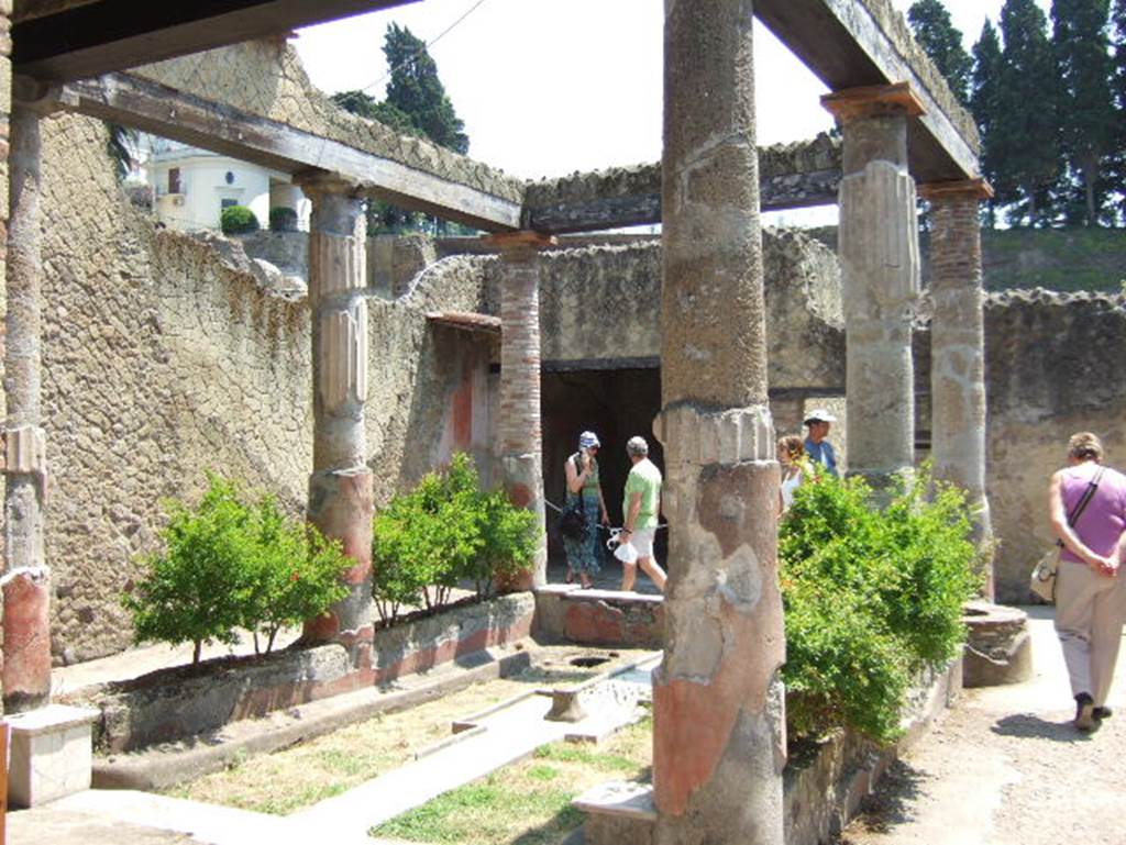 V. 30 Herculaneum, May 2006. Looking east. According to Jashemski, inserted in the low wall, on the right, was the ancient well which had been in this house from its earliest days.  See Jashemski, W. F., 1993. The Gardens of Pompeii, Volume II: Appendices. New York: Caratzas. (p.270)
