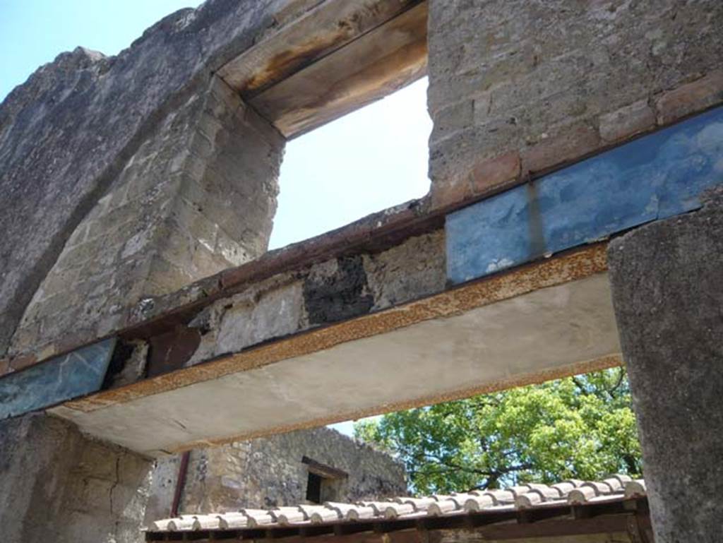 VI.8, Herculaneum. August 2013. Remains of carbonised wood above doorway, looking east from interior. Photo courtesy of Buzz Ferebee.
