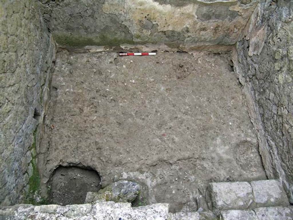 VI.12, Herculaneum. September 2005. 
Looking down on floor of rear room, with steps down in north-west corner, in lower right. 
Photo courtesy of Nicolas Monteix.
