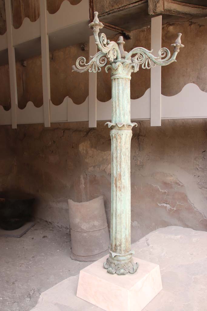 VI.12 Herculaneum. September 2019.  
Reproduction bronze candelabrum with marble base, found awaiting repair in this metal worker’s workshop.
Photo courtesy of Klaus Heese.  
