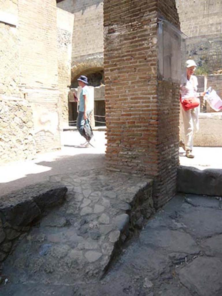 VI 12, Herculaneum, August 2013. Remains of painted serpent on street shrine on north-east corner of Insula VI, adjacent to the shop at VI.12. Looking west. Photo courtesy of Buzz Ferebee.  See also Ins. V.9.


