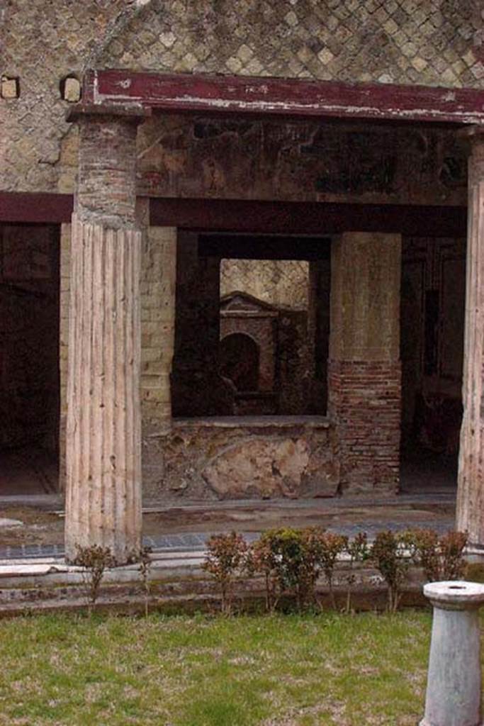 VI.13/11, Herculaneum. January 2002. 
Looking through window and doorway into Room 17, cubiculum/diaeta on south side of peristyle, towards the aedicula shrine against the south wall of the courtyard.  On the left is the doorway to the other cubiculum/diaeta, room 16. Photo courtesy of Nicolas Monteix.
