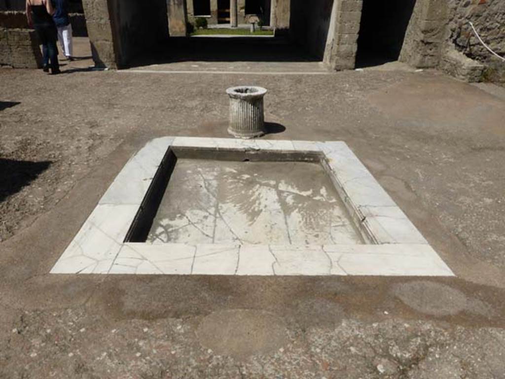 VI.13 Herculaneum, June 2014. Looking south across impluvium in atrium. 
On the right, the west ala can just be seen – a kitchen, set up in place of the original ala.  Photo courtesy of Michael Binns.

