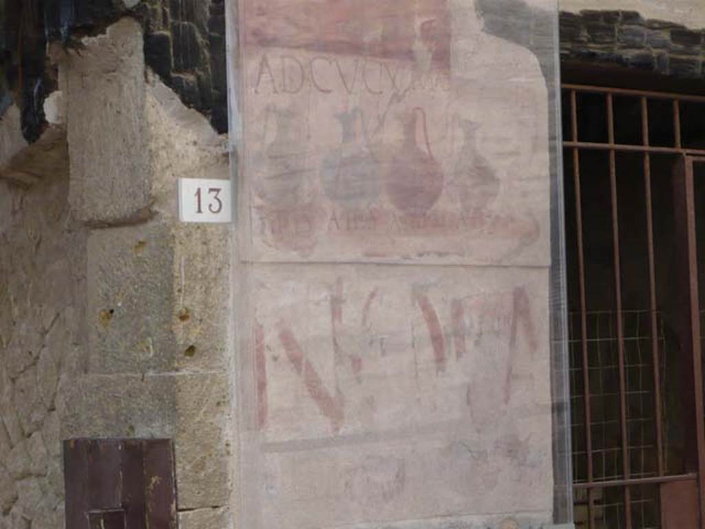 VI.13 Herculaneum on left, VI.14 on right. May 2009. 
Painted sign on pilaster between house entrance and shop. Looking south.
Photo courtesy of Buzz Ferebee.
According to Pesando and Guidobaldi, the very ancient painted graffiti NOLA, in red letters on the lower part, came to light during the restoration of the panel above. This was the announcement of a gladiatorial spectacle, inscribed by the scr (iptor) Aprilis of Capua, evidently a travelling scribe.
See Pesando, F. and Guidobaldi, M.P. (2006). Pompei, Oplontis, Ercolano, Stabiae. Editori Laterza, (p.366).
