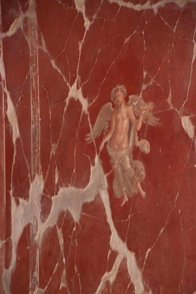 VI.17 Herculaneum. September 2019. 
Detail of painted figure in centre of panel on east wall of triclinium, on north side of doorway. 
Photo courtesy of Klaus Heese.
