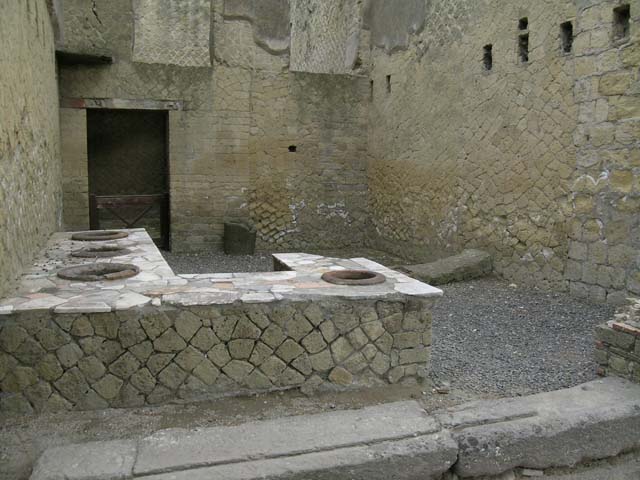 Ins Or II, 6, Herculaneum. June 2006. General view across counter, looking south-east. 
The stairs leading to the upper floor would have been against the south wall.
The latrine would have been situated in the south-west corner, behind the brick wall, on right.
Photo courtesy of Nicolas Monteix.


