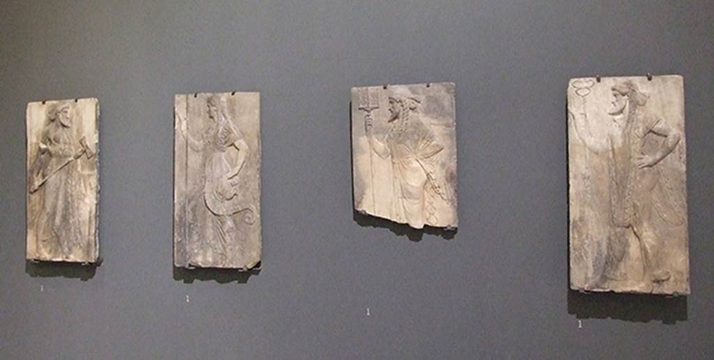 Herculaneum, March 2009. Sacred Area terrace, the shrine of Four Gods. 
Original reliefs of the four gods on display in Naples Museum.
From the left are Vulcan, Minerva, Neptune and Mercury. Now in Naples Archaeological Museum. Inventory number s.n.