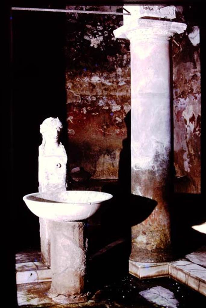Suburban baths, Herculaneum, 1975. Atrium with fountain bust of Apollo.
Photo by Stanley A. Jashemski.   
Source: The Wilhelmina and Stanley A. Jashemski archive in the University of Maryland Library, Special Collections (See collection page) and made available under the Creative Commons Attribution-Non Commercial License v.4. See Licence and use details. J75f0723

