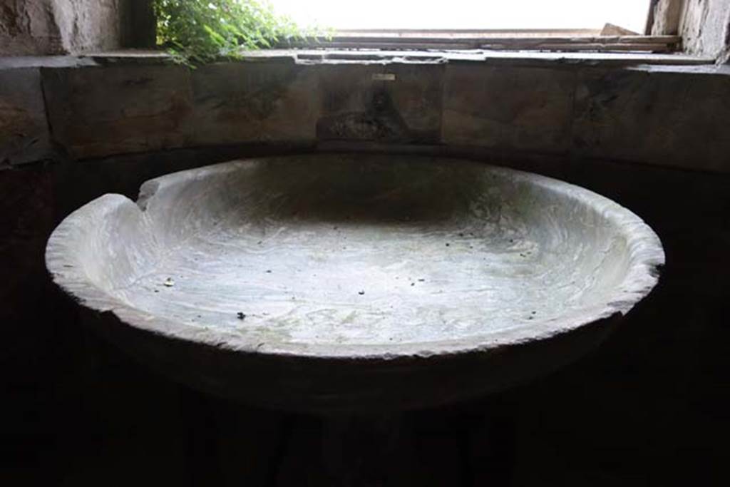 Suburban Baths, Herculaneum. June 2014. Marble basin for cold water (labrum) by the window in the smaller original caldarium. This was relocated to this position after the excavation, whereas it had been found on the opposite side of the room.
Photo courtesy of Michael Binns.
