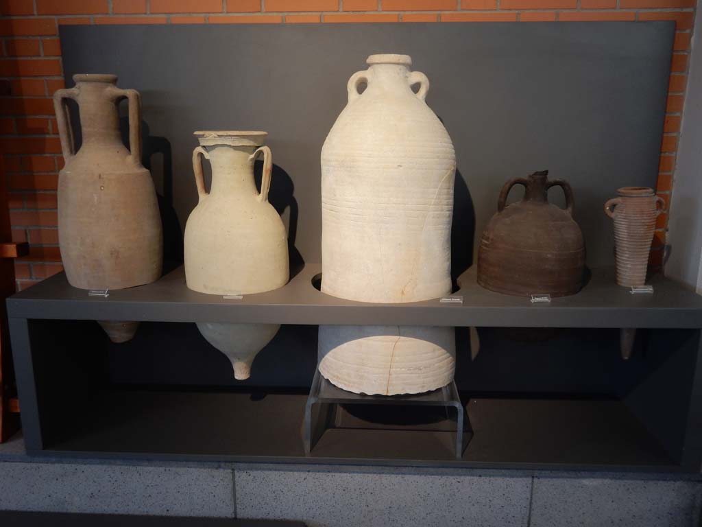 Herculaneum, June 2019. 
Types of amphorae used for wine, garum fish sauce, oil in large amphorae, high quality wine from the Aegean like the Cretan found in this smaller amphora, 
and dried fruits, like dates and plums, from the eastern Aegean and particularly the area of Palestine. Photo courtesy of Buzz Ferebee.

