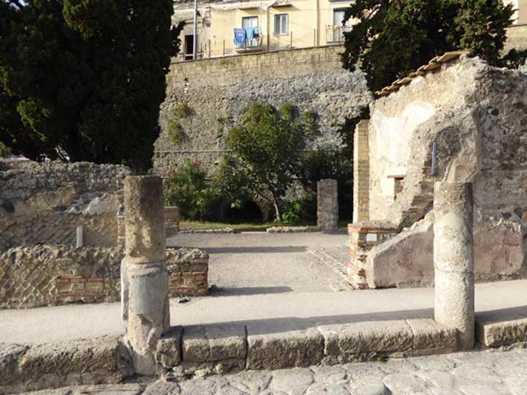 Cardo III outside II.3 Herculaneum, October 2014. Looking west towards entrance doorway. 
Embedded in the pavement are the remains of the two columns which would have supported a roof over the doorway.
Photo courtesy of Michael Binns.
