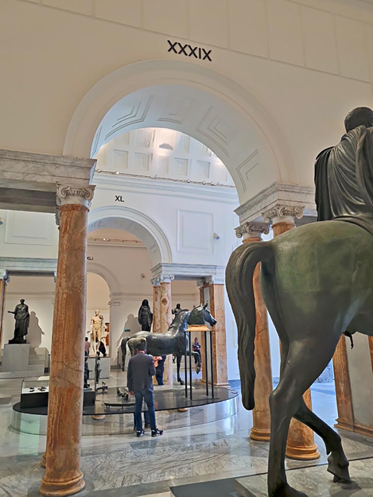 Naples Archaeological Museum, April 2023.
Looking through beautiful marble columns and pilasters, part of the “Campania Romana” gallery, towards the display of Bronze Horses.
Photo courtesy of Giuseppe Ciaramella.

