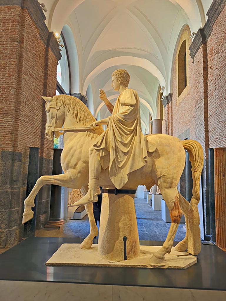 Herculaneum, public area. April 2023. 
White marble statue of Marcus Nonius Balbus, on display in “Campania Romana” gallery of Naples Archaeological Museum, inv. 6014.  
Photo courtesy of Giuseppe Ciaramella.
