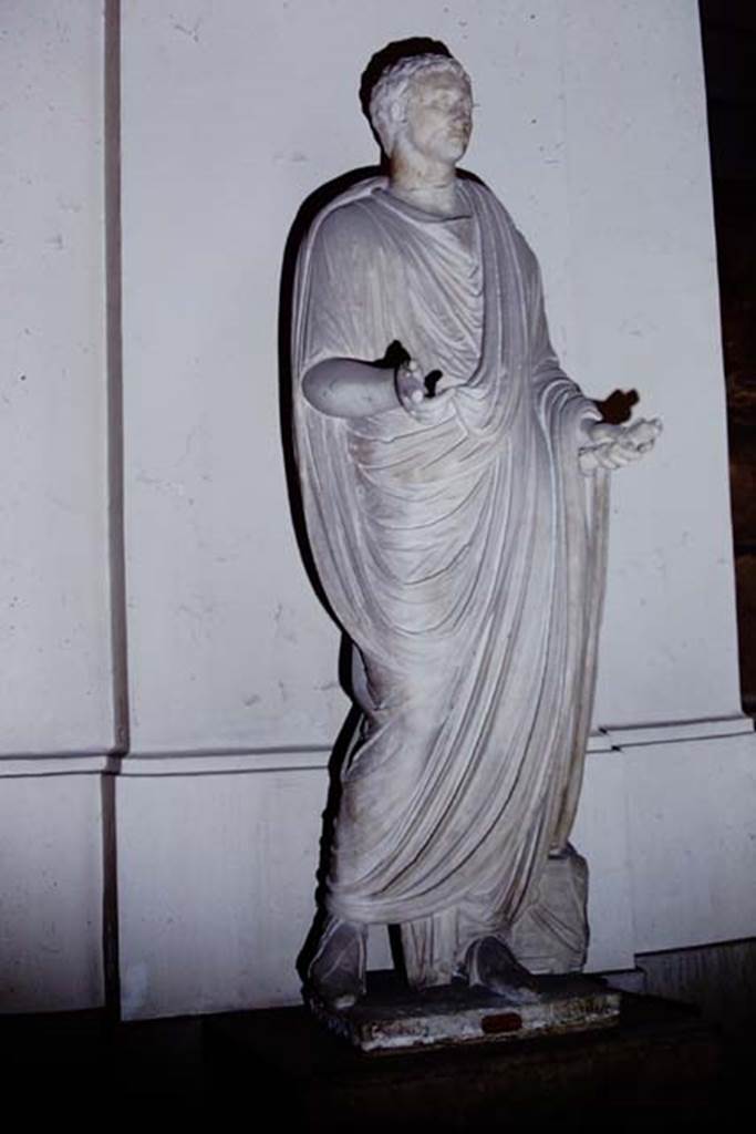 Herculaneum Theatre, 1968.  Photo by Stanley A. Jashemski.
Statue of a Magistrate. Now in Naples Archaeological Museum. Inventory number 6234.
Source: The Wilhelmina and Stanley A. Jashemski archive in the University of Maryland Library, Special Collections (See collection page) and made available under the Creative Commons Attribution-Non Commercial License v.4. See Licence and use details.
J68f1414
