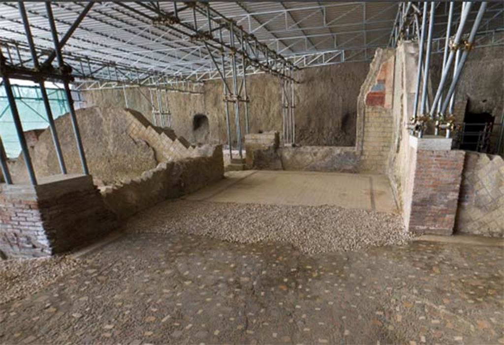 Villa dei Papiri, Herculaneum. 2009. Room (d), looking west from room (c), the atrium.
In the recent excavations three minor clearing surveys were carried out at the openings towards tablinum (b) and alae (d) and (e). During these surveys the remains of mosaics adorning the thresholds of these rooms, which were removed during the Bourbon exploration, were recovered. It is probable that these thresholds can be recognized among some of the flooring now stored in the apartments of the Reggia of Portici. 
See Pagano, M. Mosaici romani nella reggia di Portici, in: Atti del VII Colloquia dell'Associazione italiana per lo studio e la conservazione del mosaico, Pompei, 22-25 marzo 2000, ed. by A. Paribeni (Ravenna 2001), esp. 337–338 and fig. 5 – 8.
See Esposito D. and Guidobaldi M., 2010. New Archaeological Research at the Villa of the Papyri, in the Villa of the Papyri at Herculaneum. Berlin: De Gruyter, p. 26, fig. 6, fig. 7, note 8. 

