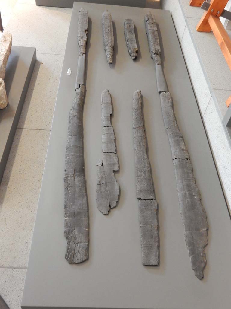 Herculaneum, June 2019. Carbonised wooden oars. 
Six oars were found in the bath building in Insula Occidentalis at Herculaneum.
Photo courtesy of Buzz Ferebee.

