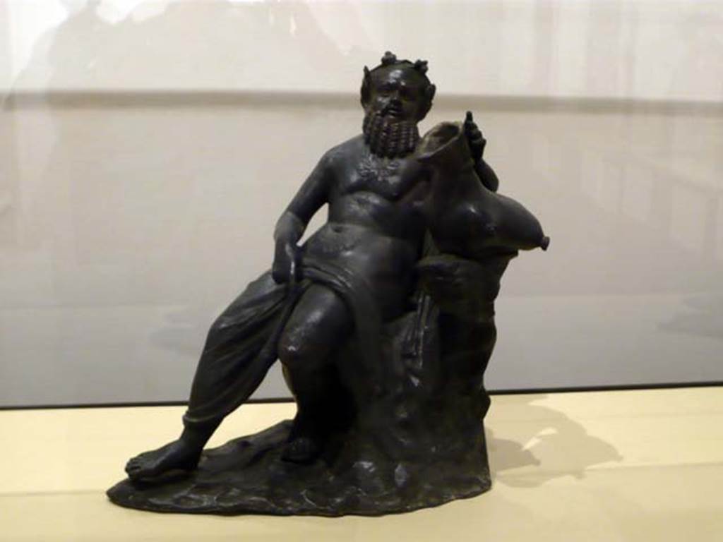 Villa dei Papiri, Herculaneum. Atrium. Bronze statue of Silenus with a wineskin and right hand on leg found in 1754 round the impluvium.
Now in Naples Archaeological Museum. Inventory number 5006. 

